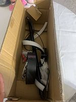 Fixture inside open box showing black frame and white LED strips