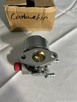 Top view of carburetor showing brass throttle bore, primer bulb and box