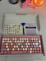 Keyboard, stickers, brush and manual inside open box