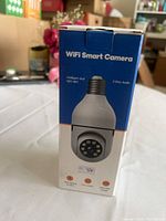 Front of sealed retail box showing product image and feature icons