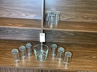 Entire set on shelves: ice bucket with tongs, six glasses on lower shelf, three additional glasses on upper shelf