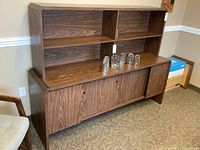 Front view of full cabinet showing lower credenza with sliding doors and upper hutch shelves