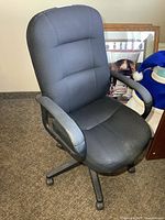 Front angled view of black fabric office chair showing overall design