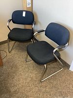 Pair of matching metal framed office chairs side by side