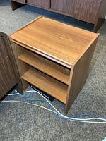 Front angled view showing overall stand and shelves