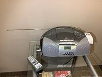 Front view of Sony boombox, antenna extended, remote shown