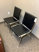 Front oblique view of both chairs showing upholstery and chrome frames