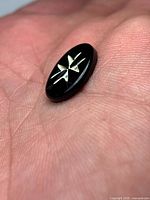 Front of onyx cabochon showing eight-pointed cross