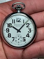 Front view showing Exacto branding, dial layout, sub-seconds, and jewel count