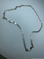 Full view of sterling Figaro chain laid out
