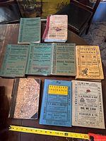 Group shot of all directories and bound magazine on table with measuring tape showing scale