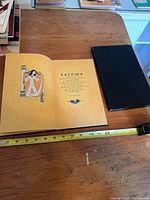 Open book showing illustrated frontispiece and title page