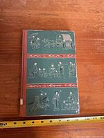 Front cover showing green illustrated boards, ruler for scale