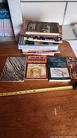 Stack of woodworking books plus four additional laid out titles