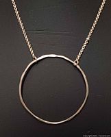 Close-up of circle pendant and chain