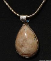 Close view of pendant front highlighting drusy quartz texture and bezel
