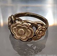 Front view of silver ring showing floral design