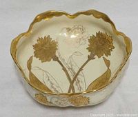 Top view showing floral gilt interior and scalloped rim