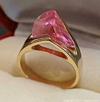 Side view showing gold plated band and pink fan-cut crystal