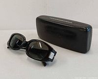 Front view of sunglasses and case