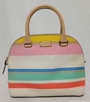 Front view of striped satchel showing logo plate, handles and pattern