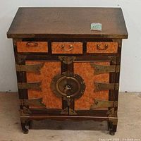 Front view showing drawers, doors, brass hardware, key and lock