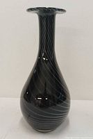 Full view of black Murano vase with white spiral