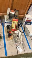 Group view showing glass grinder, Weller kit, loose iron, solder wire, flux block