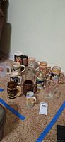 Group shot of all steins and mugs on floor