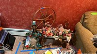 Full view of wooden spinning wheel with attached faux flowers