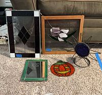 All five stained glass items displayed on carpet
