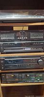Stack of audio components: turntable lid edge, equalizer, receiver, cassette deck
