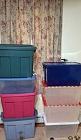 Full stack showing eight assorted plastic bins with lids
