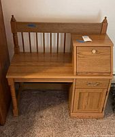 Front view of telephone bench showing spindle backrest and storage unit