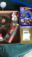 Boxed lot showing ashtray, Marlboro pack, glass jar of matchbooks, Camel match tin