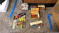 All five boxed slot cars laid out on carpet