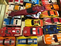 Close view of right half of tin showing multiple slot cars