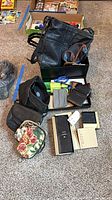 Lot overview: handbags, wallets, coin purses inside and around box