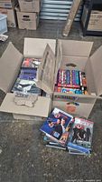 Two open boxes showing numerous DVDs and box sets