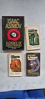 Front covers of the four Isaac Asimov books