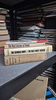 Stack of four WWII history books on shelf