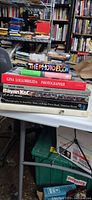 Stack of seven photography books on table