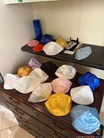 Full lot showing kippot on dresser, mezuzah, ornament pouch and glass cylinder