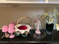 All items grouped: LED lamps, basket, cloche with figurine, faux floral arrangement