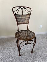 Front view of metal accent chair showing lattice seat and back, rope motif