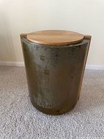 Front view showing cylindrical form and wood top