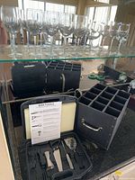 Overview of stemmed glasses on shelf, tool case, and storage box