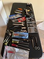 Overview of entire lot on table showing quantity and variety of tools