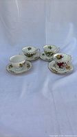 Group shot of four teacup-and-saucer duos