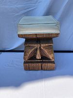 front view showing carved wood base and cushion